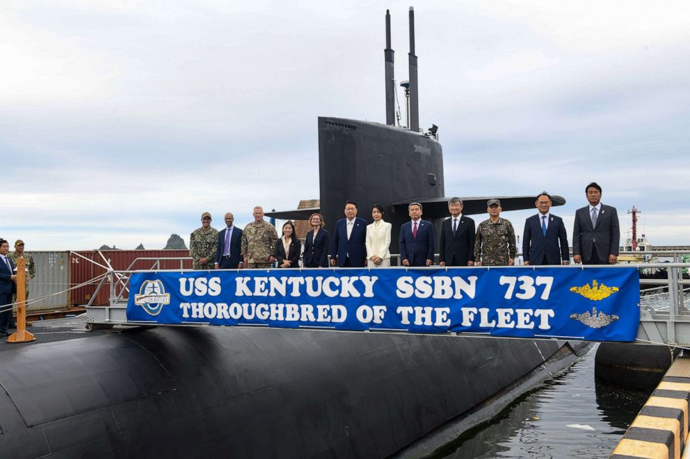 PHOTO: Republic of Korea President Yoon Suk Yeol and First Lady Kim Keon Hee take a photo with the U.S. and ROK delegations aboard the USS Kentucky, a U.S. nuclear-armed submarine, anchored at the Busan Naval Base in Busan, South Korea, July 19, 2023.