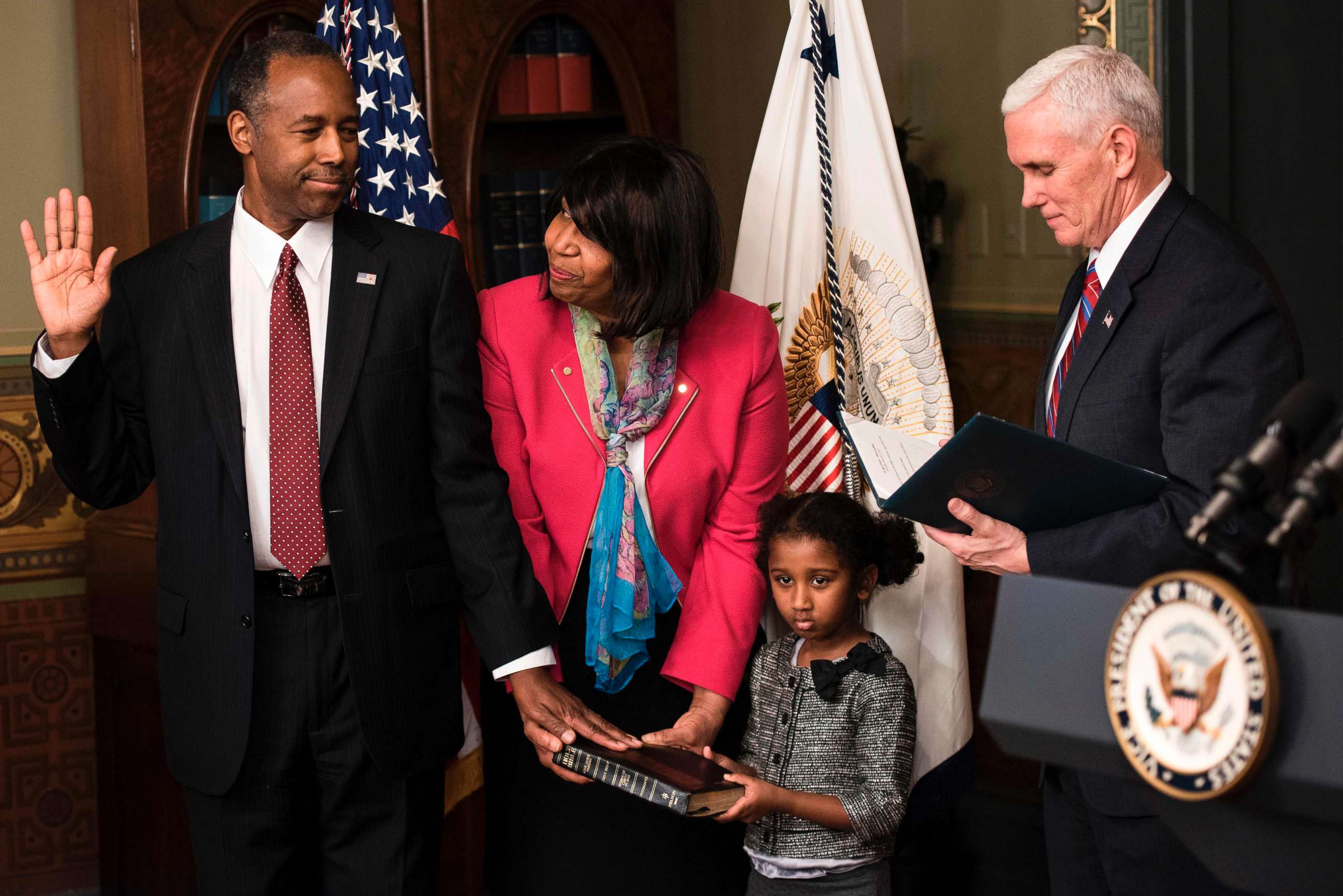 PHOTO: Ben Carson is sworn in as U.S. Secretary of Housing and Urban Development by Vice President Mike Pence (R) as his wife Candy Carson and granddaughter Tesora Carson watch during a ceremony, March 2, 2017. in Washington, D.C. 
