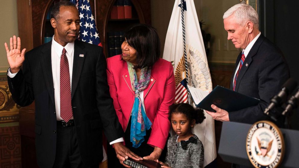 PHOTO: Ben Carson is sworn in as U.S. Secretary of Housing and Urban Development by Vice President Mike Pence (R) as his wife Candy Carson and granddaughter Tesora Carson watch during a ceremony, March 2, 2017. in Washington, D.C. 