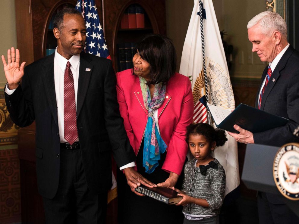 PHOTO: Ben Carson is sworn in as U.S. Secretary of Housing and Urban Development by Vice President Mike Pence (R) as his wife Candy Carson and granddaughter Tesora Carson watch during a ceremony, March 2, 2017. in Washington, D.C.