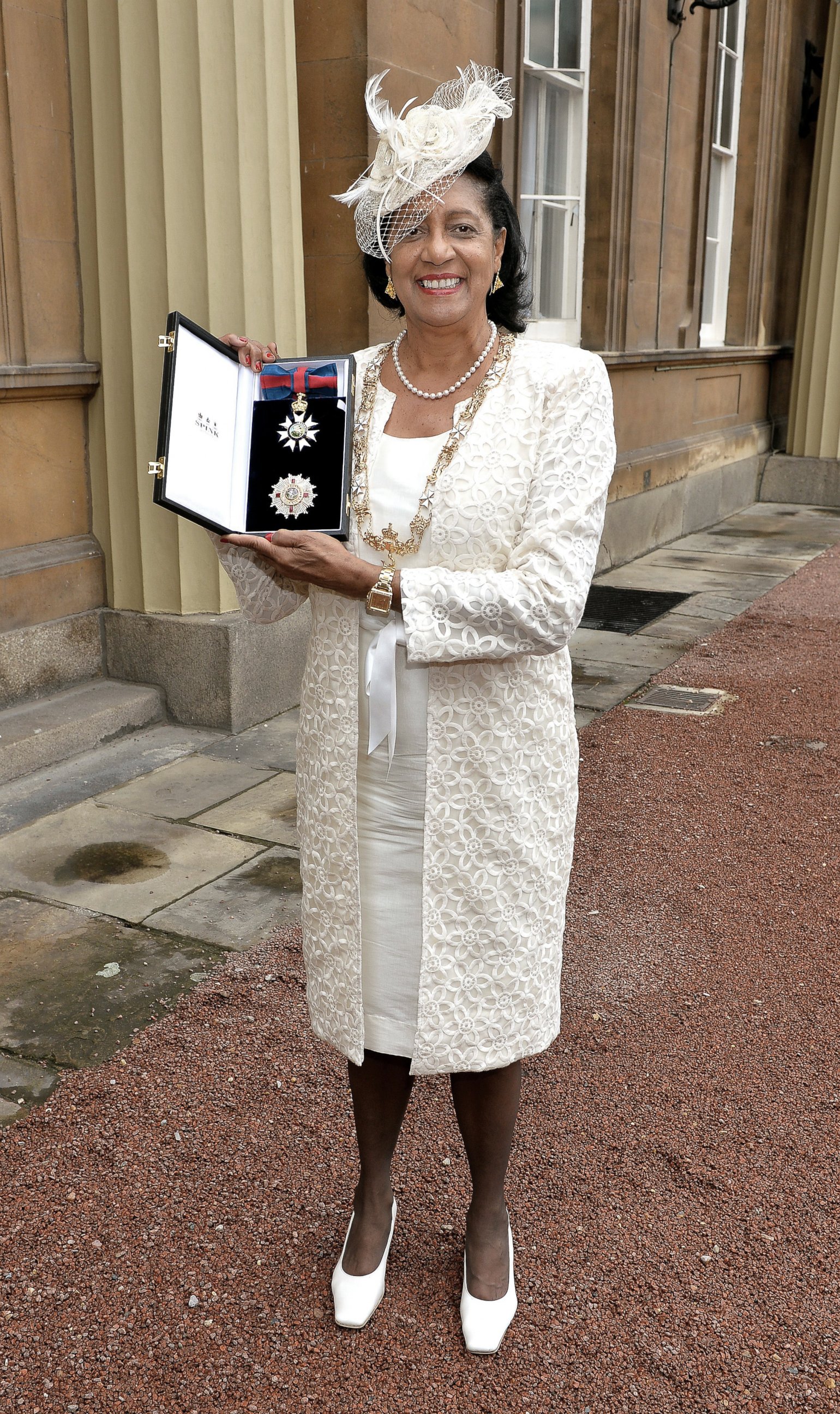 PHOTO: Governor General of Grenada, Dame Cecile La Grenade, holds her Insignia of the Most Distinguished Order of Saint Michael and Saint George after she was awarded Dame Grand Gross by the Prince of Wales at Buckingham Palace, London, July 11, 2014.