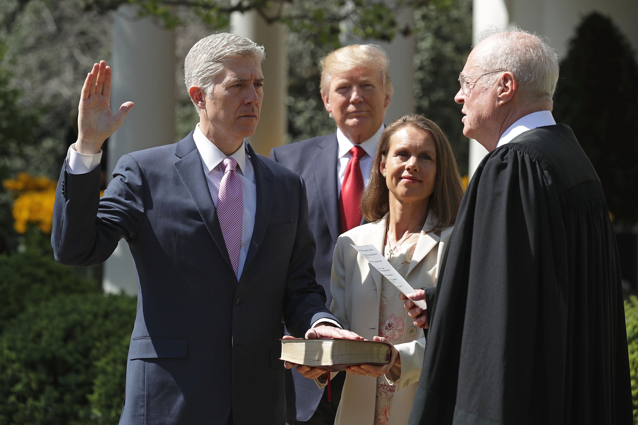PHOTO: Supreme Court Associate Justice Anthony Kennedy administers the judicial oath to Judge Neil Gorsuch as President Donald Trump looks on during a ceremony in the Rose Garden at the White House April 10, 2017 in Washington.