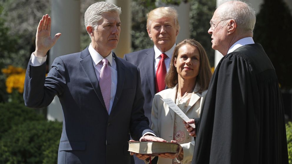Supreme Court Associate Justice Anthony Kennedy administers the judicial oath to Judge Neil Gorsuch as his wife Marie Louise Gorsuch holds a bible and President Donald Trump looks on during a ceremony in the Rose Garden at the White House April 10, 2017 in Washington.