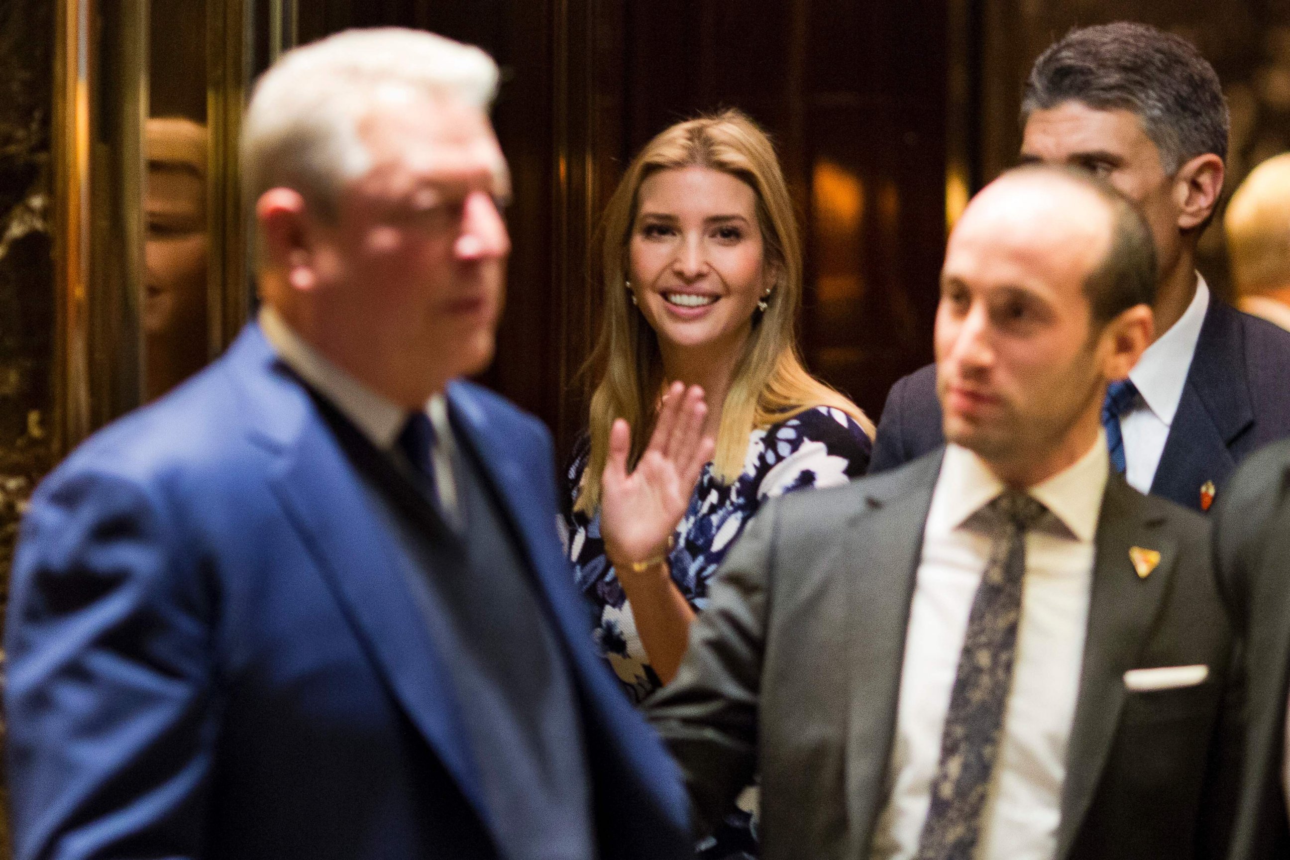 PHOTO: Ivanka Trump(C) waves from the elevator as former US Vice President Al Gore(L) leaves meetings at Trump Tower in New York City, Dec. 5, 2016.