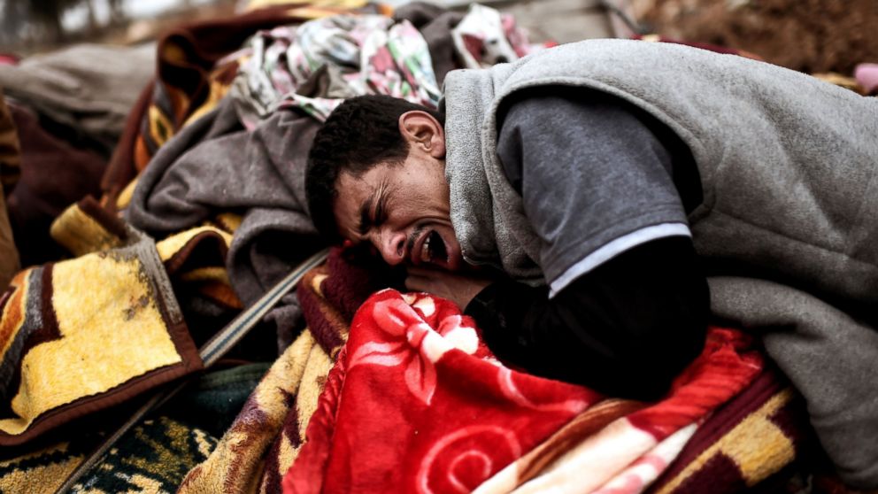 Relatives mourn as bodies of Iraqi residents of west Mosul killed in an airstrike targeting Islamic State (IS) group jihadists are placed and covered with blankets on carts, March 17, 2017.