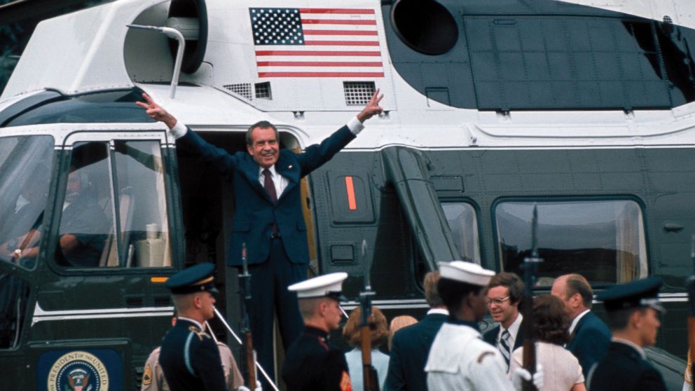PHOTO: President Richard Nixon raises his hands with his trademark "V" sign in the doorway of a helicopter after leaving the White House following his resignation over the Watergate scandal, Aug. 9, 1974. 