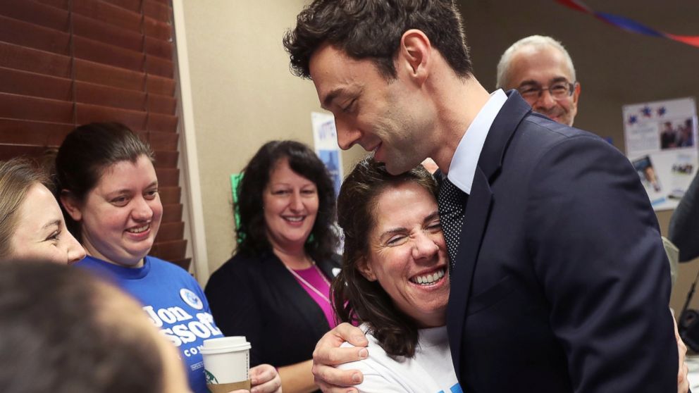 PHOTO: Dianne Kaufman is hugged by Democratic candidate Jon Ossoff as he greets  volunteers and supporters at a campaign office on April 18, 2017 in Atlanta. 