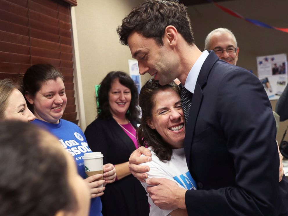 PHOTO: Dianne Kaufman is hugged by Democratic candidate Jon Ossoff as he greets  volunteers and supporters at a campaign office on April 18, 2017 in Atlanta. 