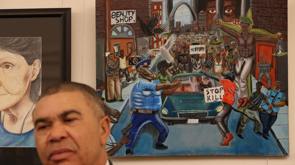 Rep. William Lacy Clay (D-MO) speaks to the media after helping rehang a painting (seen behind him) on the U.S. Capitol walls after it was removed by Rep. Duncan Hunter (R-CA) on Friday because he found it offensive, Jan. 10, 2017 in Washington.  The painting is part of a larger art show hanging in the Capitol and is by a recent high school graduate, David Pulphus, from Clay's district and depicts his interpretation of civil unrest in and around the 2014 events in Ferguson, Missouri. 