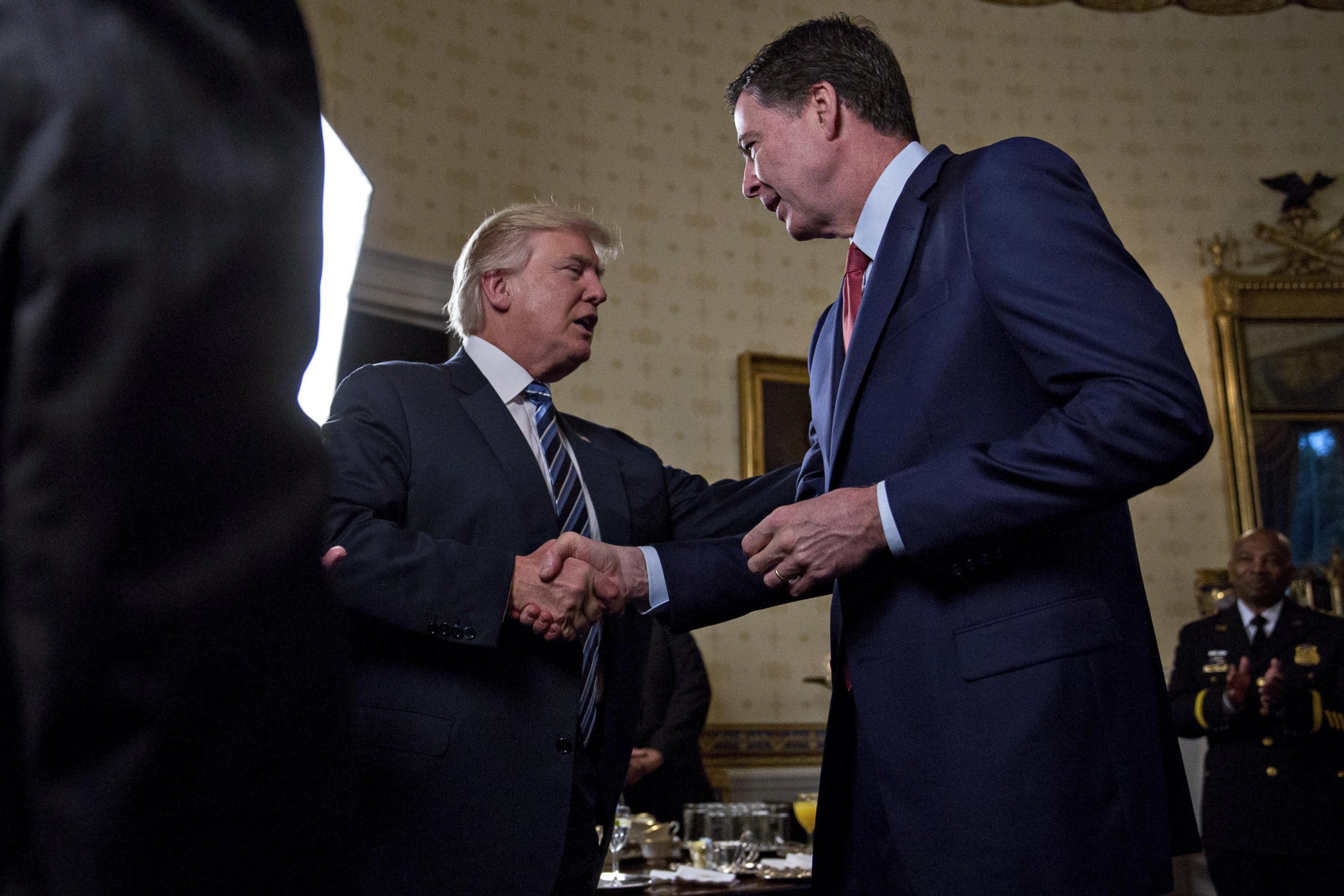 PHOTO: President Donald Trump shakes hands with James Comey, director of the FBI, during areception in the Blue Room of the White House in Washington, D.C., Jan. 22, 2017.