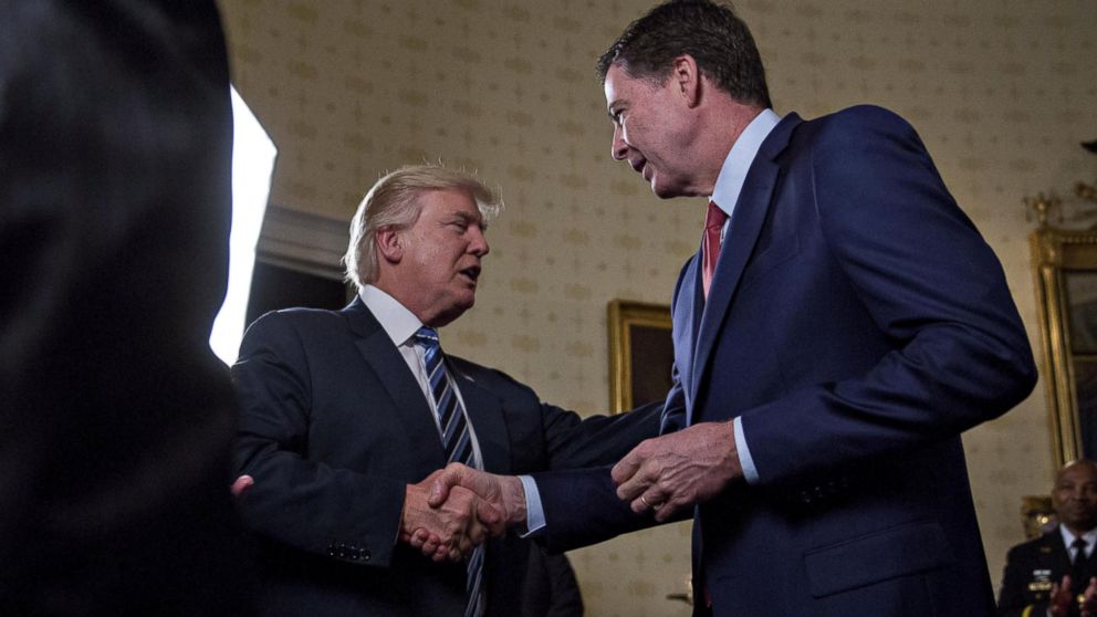 PHOTO: President Donald Trump shakes hands with James Comey, director of the FBI, during areception in the Blue Room of the White House in Washington, D.C., Jan. 22, 2017.