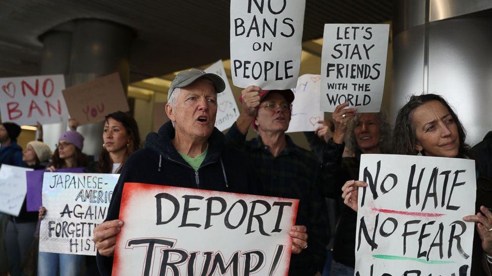 Protesters stand together at the Miami International Airport against the executive order that President Donald Trump signed restricting travelers from seven predominantly Muslim countries, Jan. 29, 2017 in Miami. 