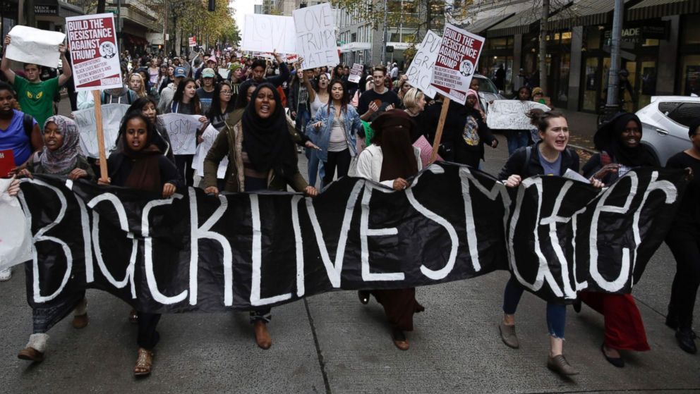 People carry a 'Black Lives Matter' banner during a student walkout protest against US President-elect Donald Trump in Seattle, Nov. 14, 2016.  