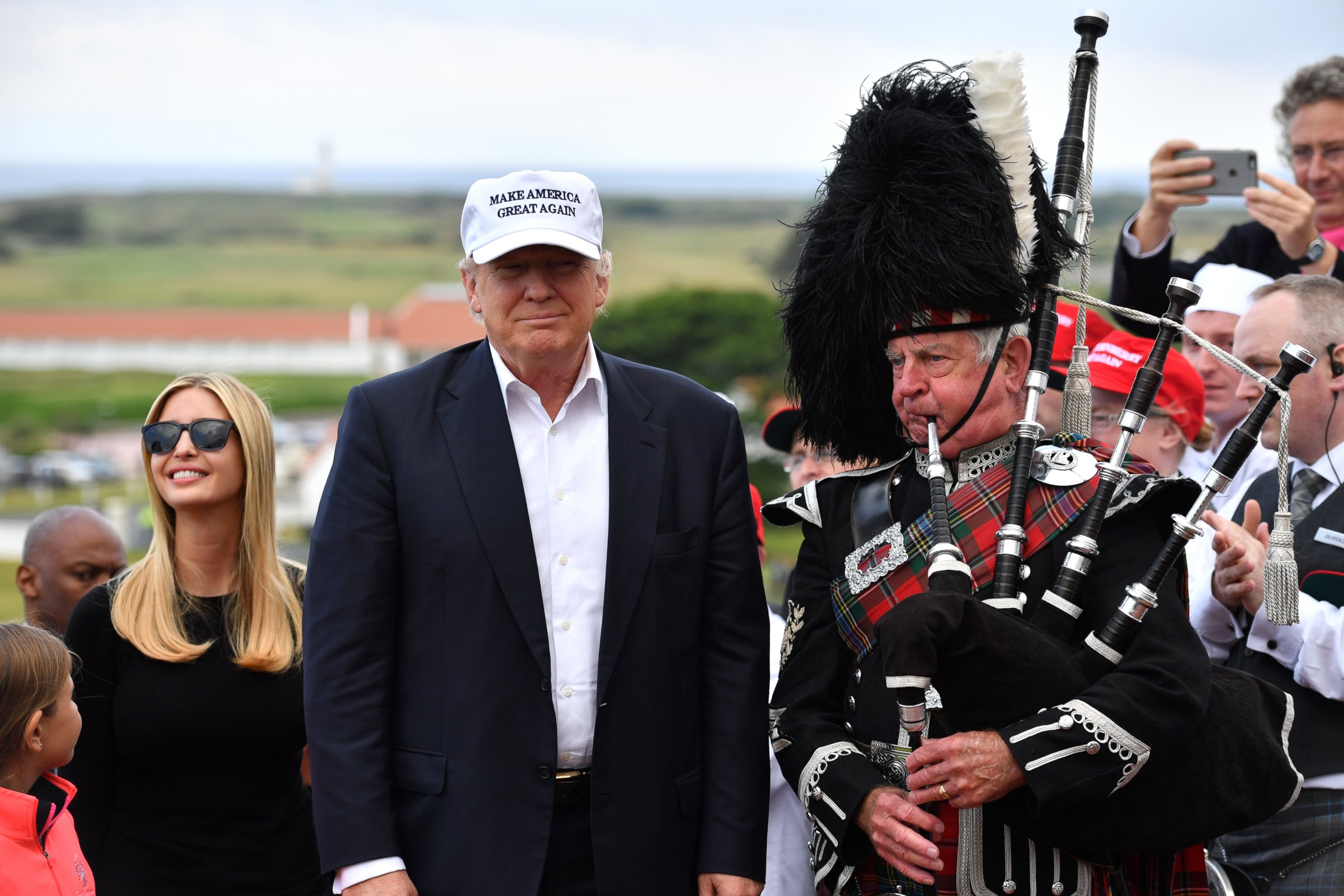 PHOTO: A bagpipe player wears traditional dress next to Donald Trump and his family as they arrive to his Trump Turnberry Resort, June 24, 2016, in Ayr, Scotland.