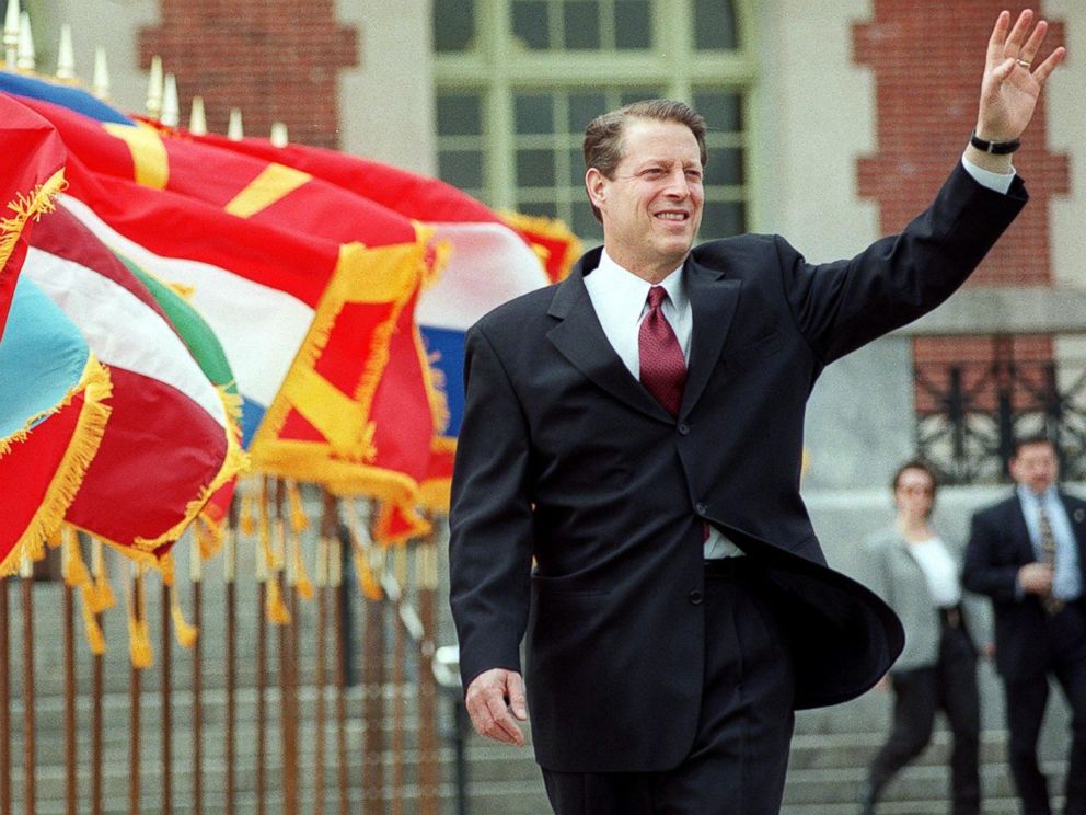 PHOTO: Al Gore waves as he walks past a row of flags at the start of the Commemoration Ceremony of the 50th Anniversary of the North Atlantic Treaty Organization in New York, April 21, 1999.