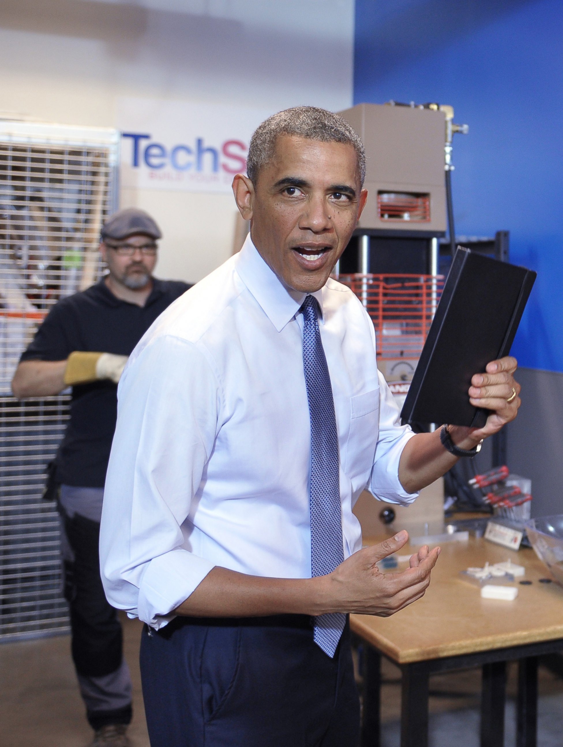 PHOTO: US President Barack Obama shows his ipad case which was prototyped at TechShop Pittsburgh on June 17, 2014 in Pittsburgh, Penn. 