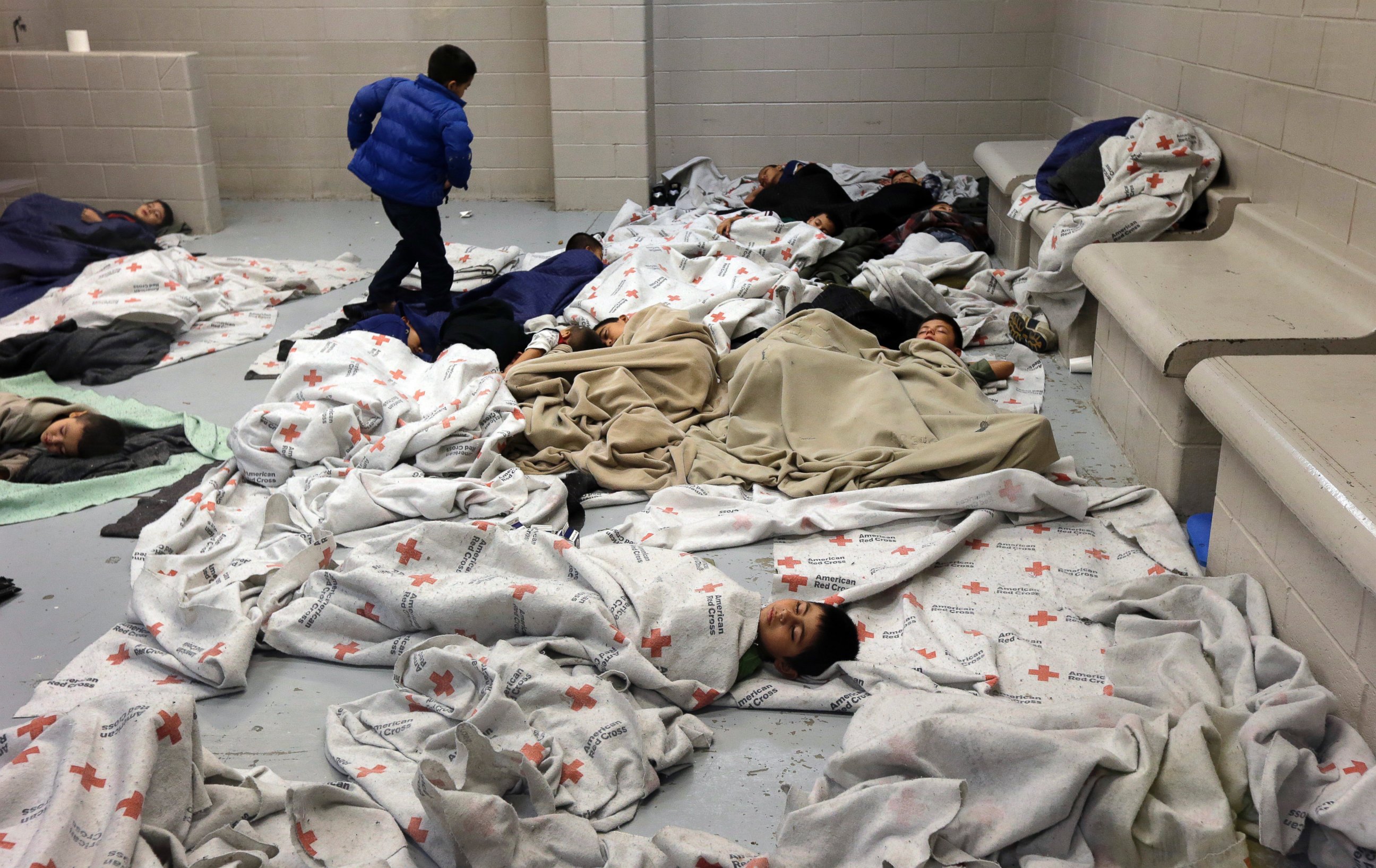 PHOTO: Detainees sleep in a holding cell at a U.S. Customs and Border Protection processing facility, on June 18, 2014, in Brownsville, Texas.