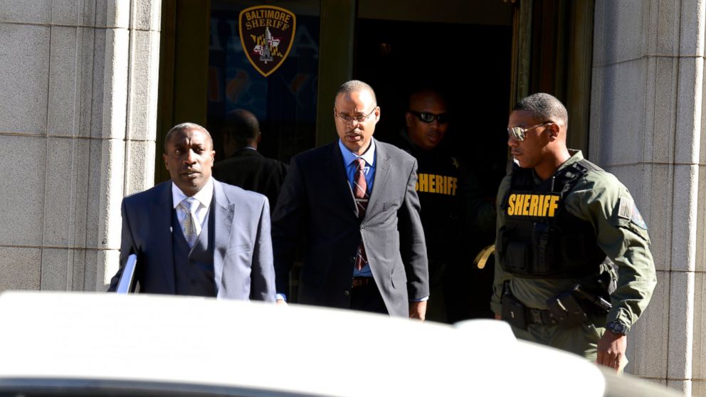 Baltimore Police Officer Caesar Goodson Jr., center, exits the Circuit Court on the first day in the trial, June 9, 2016 in Baltimore, Maryland. Officer Goodson, the van driver in the Freddie Gray case, is facing multiple charges including second-degree murder. 