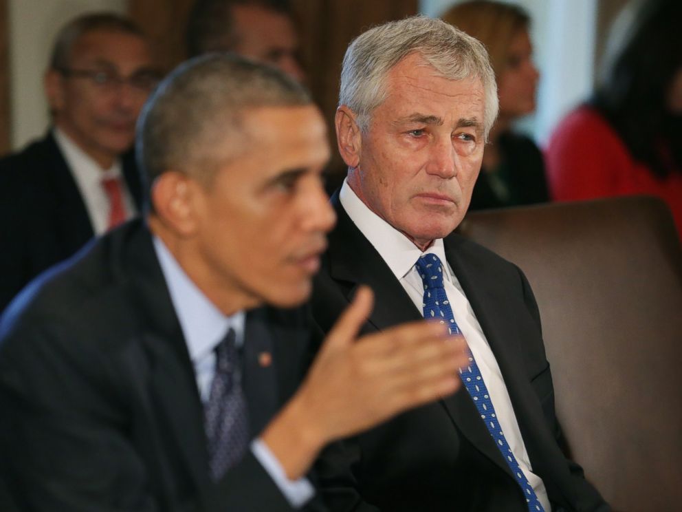 PHOTO: Defense Secretary Chuck Hagel, right, listens as President Barack Obama speaks to members of the news media.