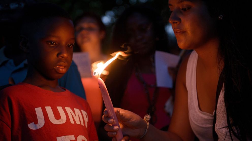 People participate in a candle light vigil at Marion Square near the Emanuel AME Church in Charleston, S.C., June 18, 2015.