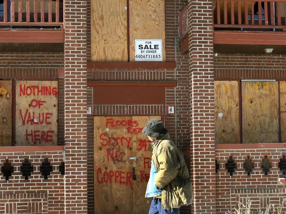 PHOTO: A resident walks past a boarded up building in the Mount Pleasant section of Cleveland, Ohio, Jan. 25, 2008.