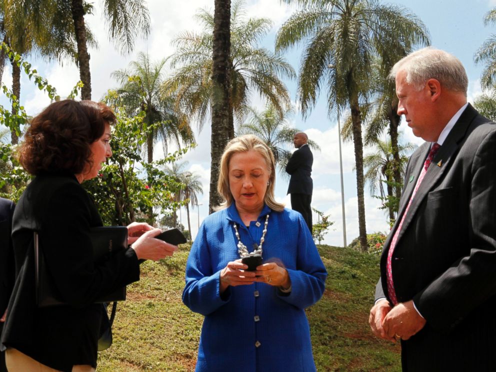 PHOTO: Secretary of State Hillary Rodham Clinton writes on her cell phone with Roberta S. Jacobson, left, and Thomas Shannon in Brasilia, Brazil, April 17, 2012.