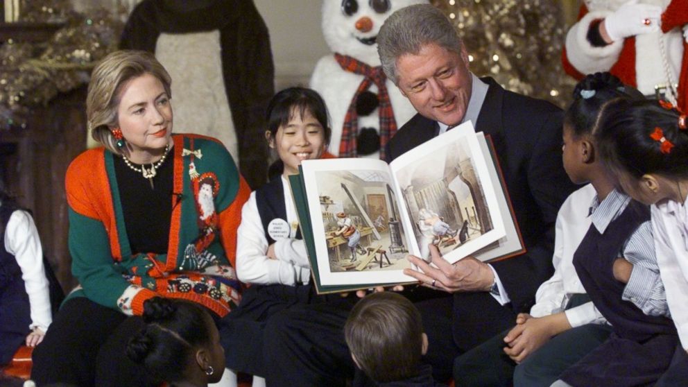 PHOTO: Bill Clinton (R) and Hillary Clinton (L) read 'Twas the Night Before Christmas' to a group of 60 children from 13 DC Schools in the East Room of the White House, Dec. 22, 1998.