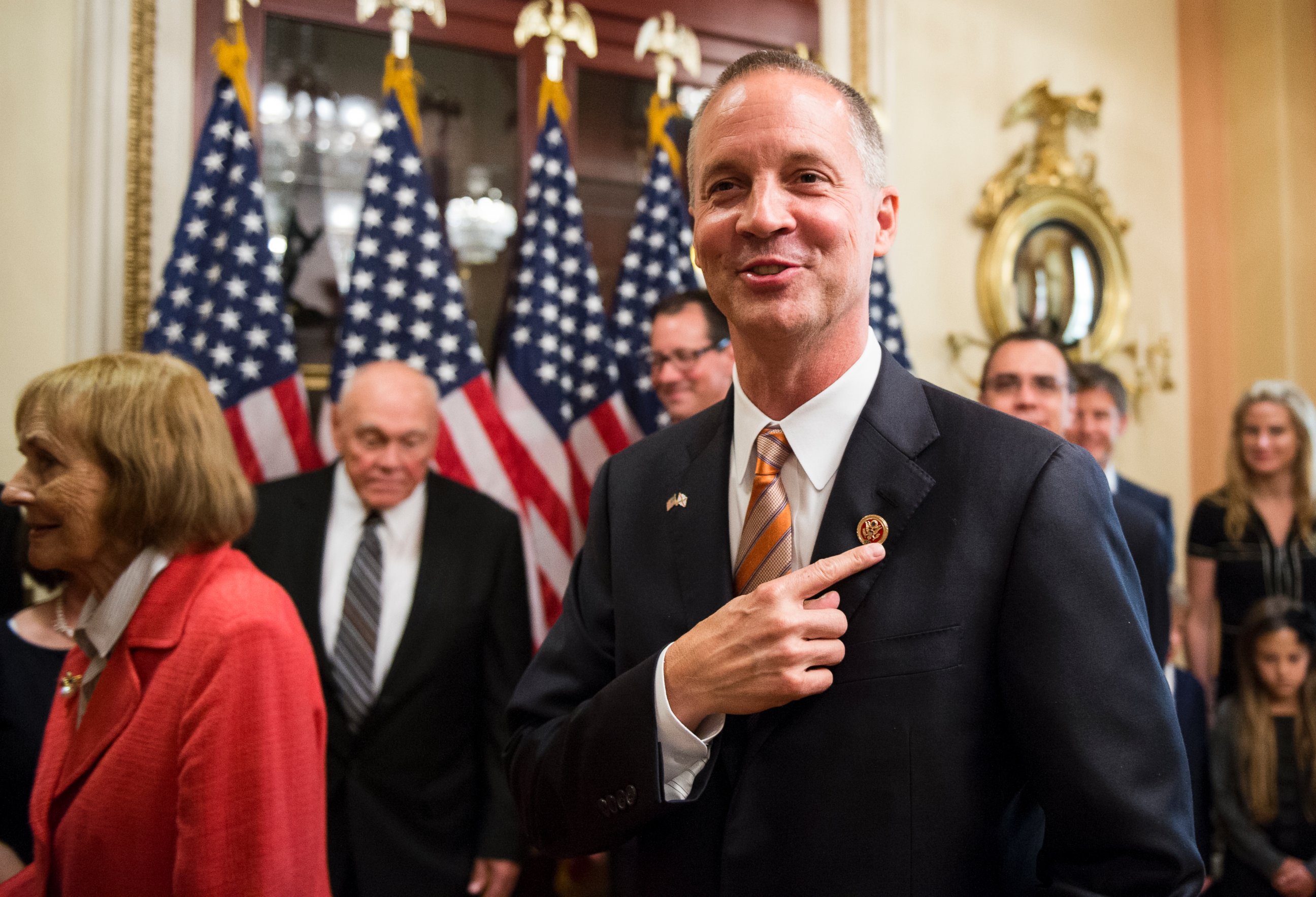 PHOTO: Curt Clawson points to his member pin after the ceremonial swearing-in photo opportunity in the Capitol on June 25, 2014.