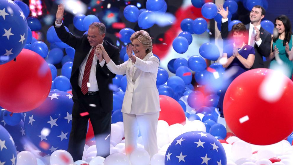 Democratic presidential nominee Hillary Clinton and vice presidential candidate Tim Kaine acknowledge the crowd at the end on the fourth day of the Democratic National Convention as balloons fall, July 28, 2016 in Philadelphia.