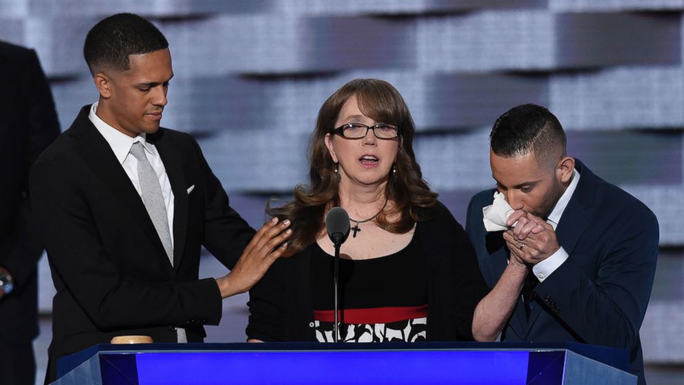 Christine Leinonen, mother of Christopher "Drew" Leinonen, killed in the Pulse nightclub attack in Orlando, Florida, is joined by survivors Brandon Wolf, left, and Jose Arriagada, on stage at the Democratic National Convention in Philadelphia, July 27, 2016.