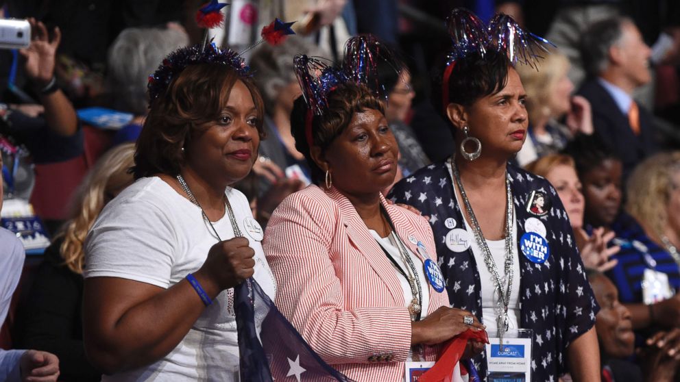 PHOTO: Women hold a U.S. flag as they listen to mothers that have lost children to gun violence, part of the Mothers of the Movement group, speak during the second day of the Democratic National Convention, July 26, 2016 in Philadelphia.