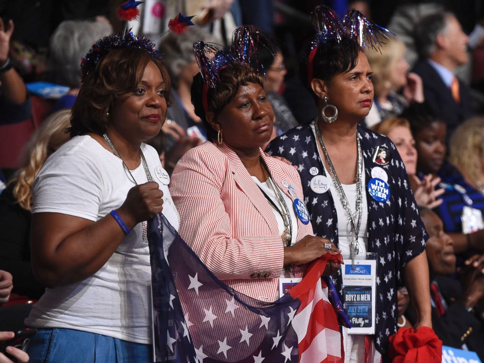PHOTO: Women hold a U.S. flag as they listen to mothers that have lost children to gun violence, part of the Mothers of the Movement group, speak during the second day of the Democratic National Convention, July 26, 2016 in Philadelphia.