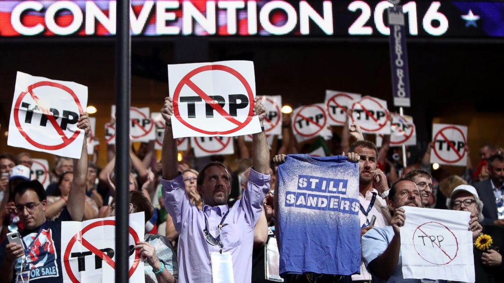 PHOTO: Delegates hold up signs protesting the Trans-Pacific Partnership (TPP) on the first day of the Democratic National Convention at the Wells Fargo Center, July 25, 2016, in Philadelphia.
