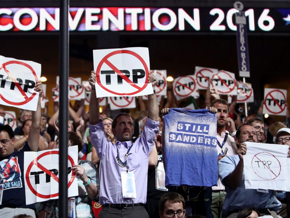 PHOTO: Delegates hold up signs protesting the Trans-Pacific Partnership (TPP) on the first day of the Democratic National Convention at the Wells Fargo Center, July 25, 2016, in Philadelphia.