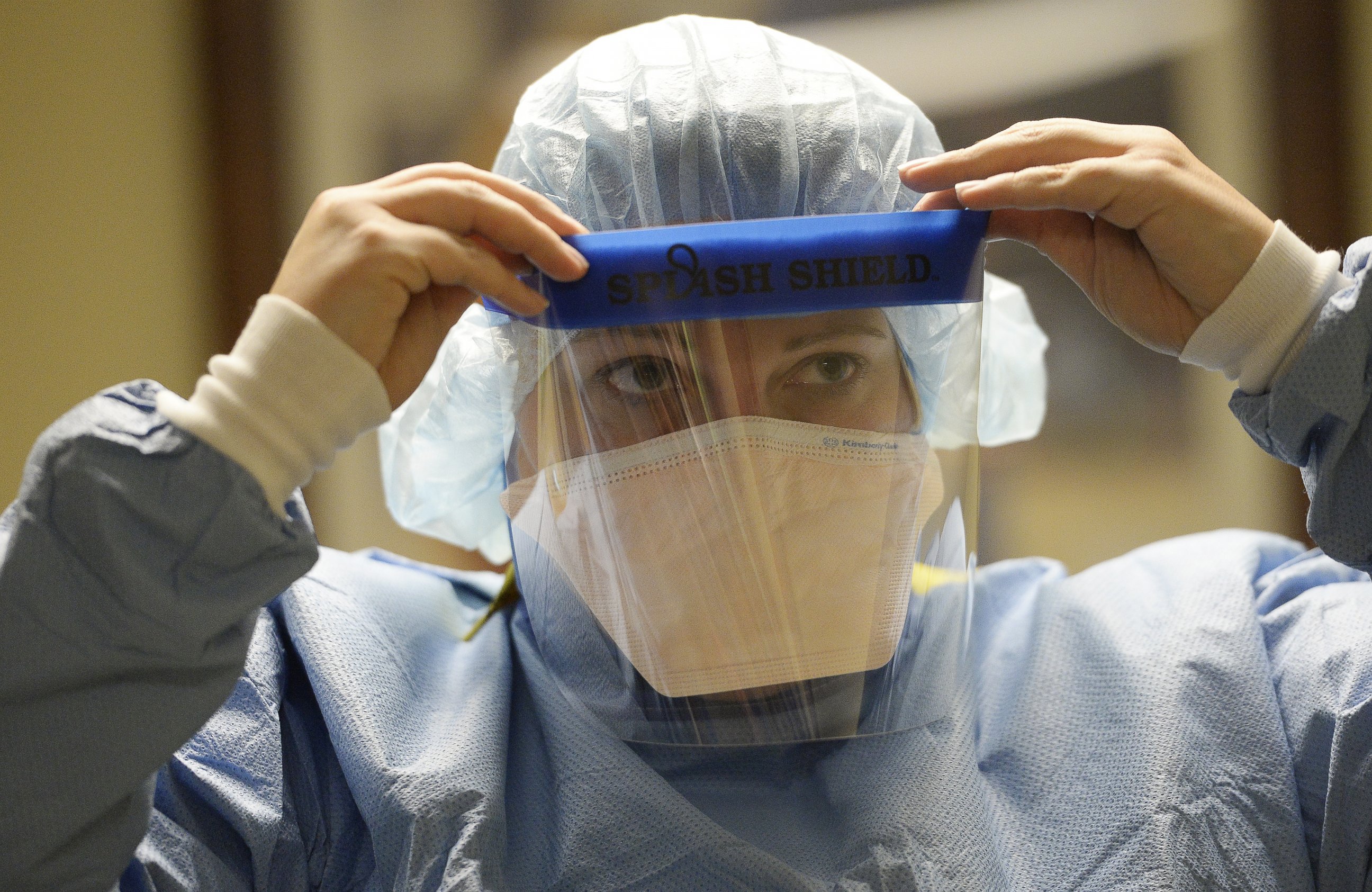 PHOTO: A clinical nurse coordinator at Presbyterian/St. Luke's Medical Center in Denver, Colo. adjusts her face shield during training for the treatment of Ebola patients on Oct. 14, 2014.
