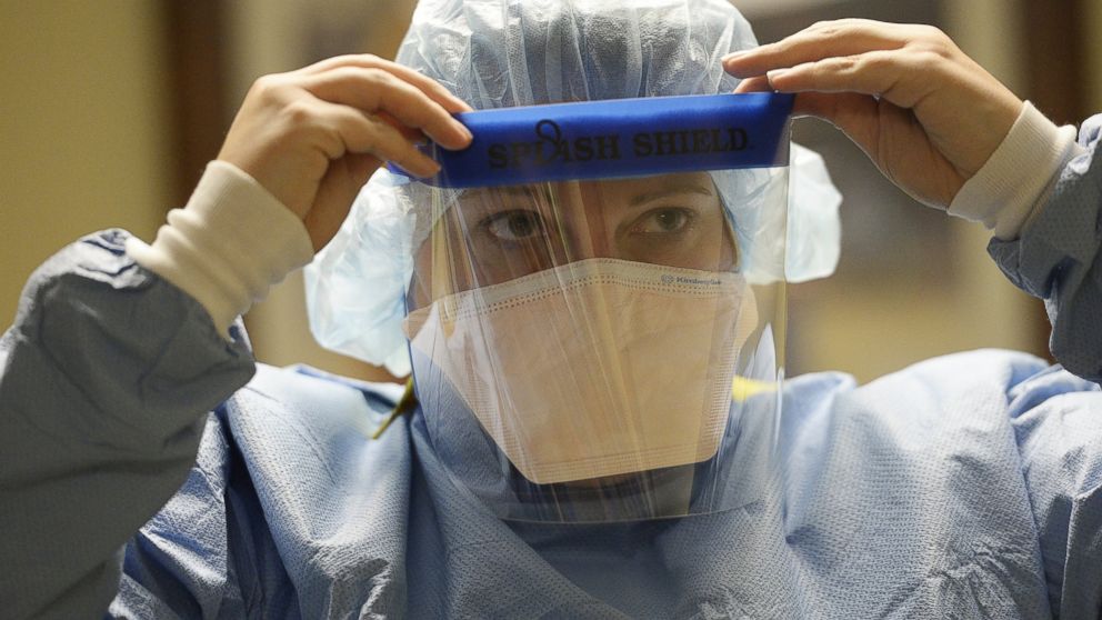 PHOTO: A clinical nurse coordinator at Presbyterian/St. Luke's Medical Center in Denver, Colo. adjusts her face shield during training for the treatment of Ebola patients on Oct. 14, 2014.