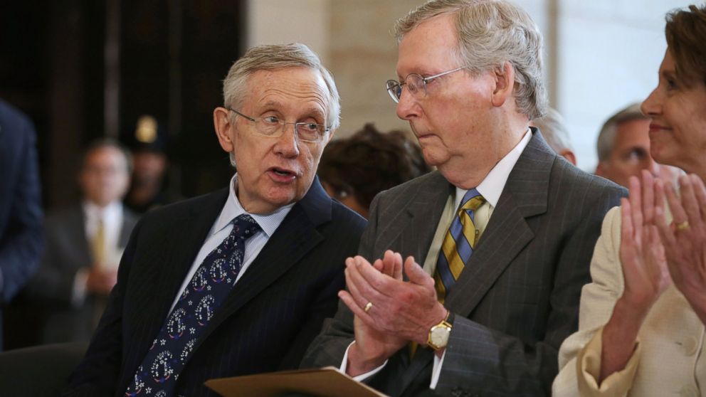 Senate Majority Leader Harry Reid, D-Nev., left, and Senate Minority Leader Mitch McConnell, R-Ky., attend a ceremony honoring former South African President Nelson Mandela on Capitol Hill, July 18, 2013, in Washington.