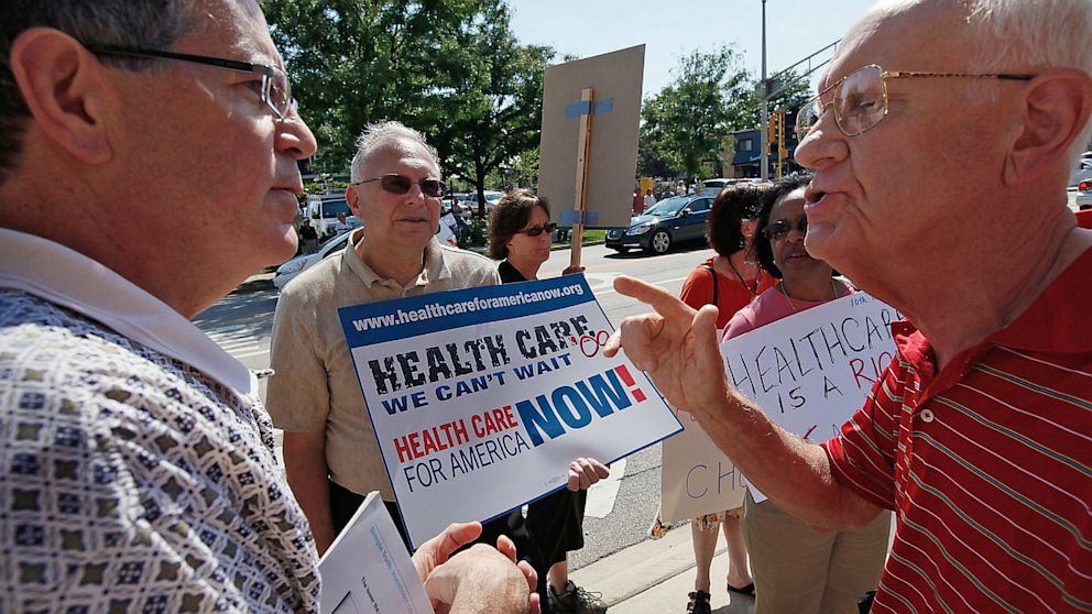 Opponents argue the merits of health insurance reform outside a town hall meeting hosted by Rep. Mark Kirk, R-Ill., in Arlington Heights, Ill., in this Aug. 24, 2009 photo.