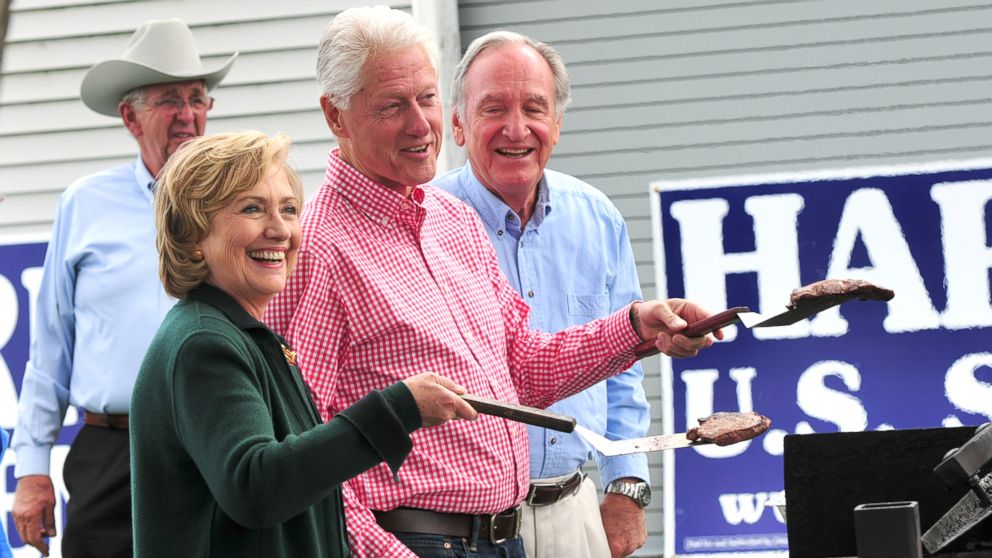 Former President Bill Clinton and his wife, former Secretary of State Hillary Rodham Clinton and Senator Tom Harkin flip steaks at the 37th Harkin Steak Fry, Sept. 14, 2014 in Indianola, Iowa.  