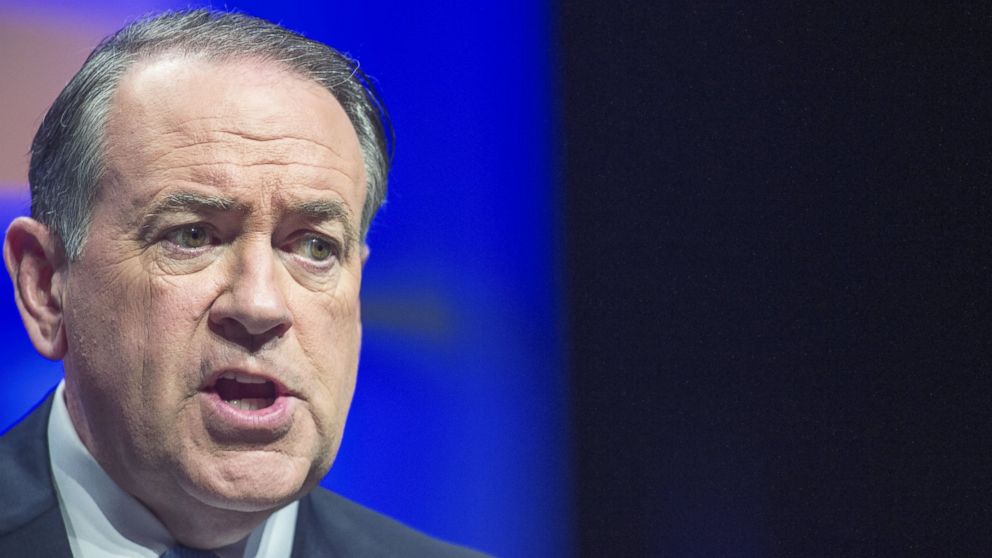 Mike Huckabee speaks to the media shortly before his speech at the 10th Annual Christians United for Israel Summit, July 13, 2015, at the Washington Convention Center, in Washington.