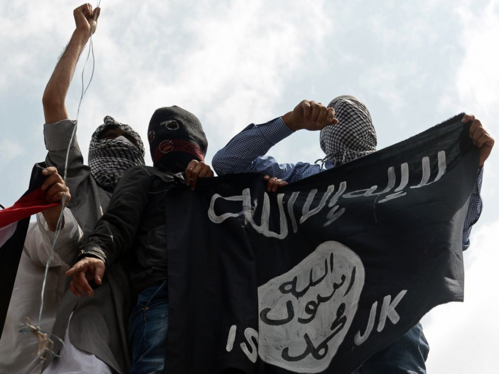 PHOTO: Kashmiri demonstrators hold up a flag of the Islamic State of Iraq and the Levant (ISIL) during a demonstration against Israeli military operations in Gaza, in downtown Srinagar, July 18, 2014. 