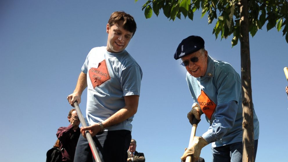  Former president Jimmy Carter, center, and his wife Rosalyn, right, and their grand son Jason are tree planting during their participating in the day service with the Georgia Delegation at Bicentennial Park in Aurora on August 27, 2008.