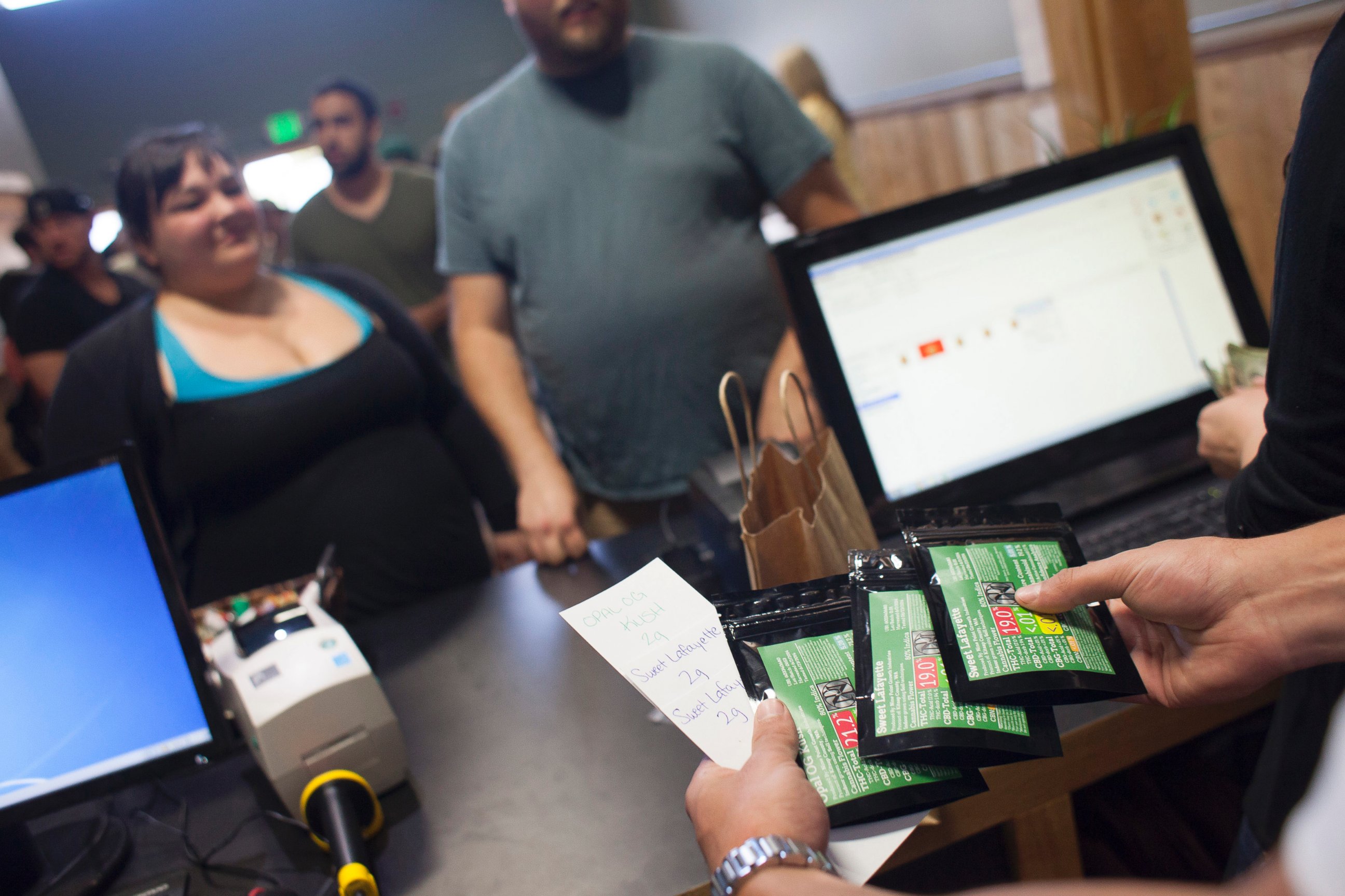 PHOTO: Customers purchase marijuana at Top Shelf Cannabis, a retail marijuana store, on July 8, 2014 in Bellingham, Washington.