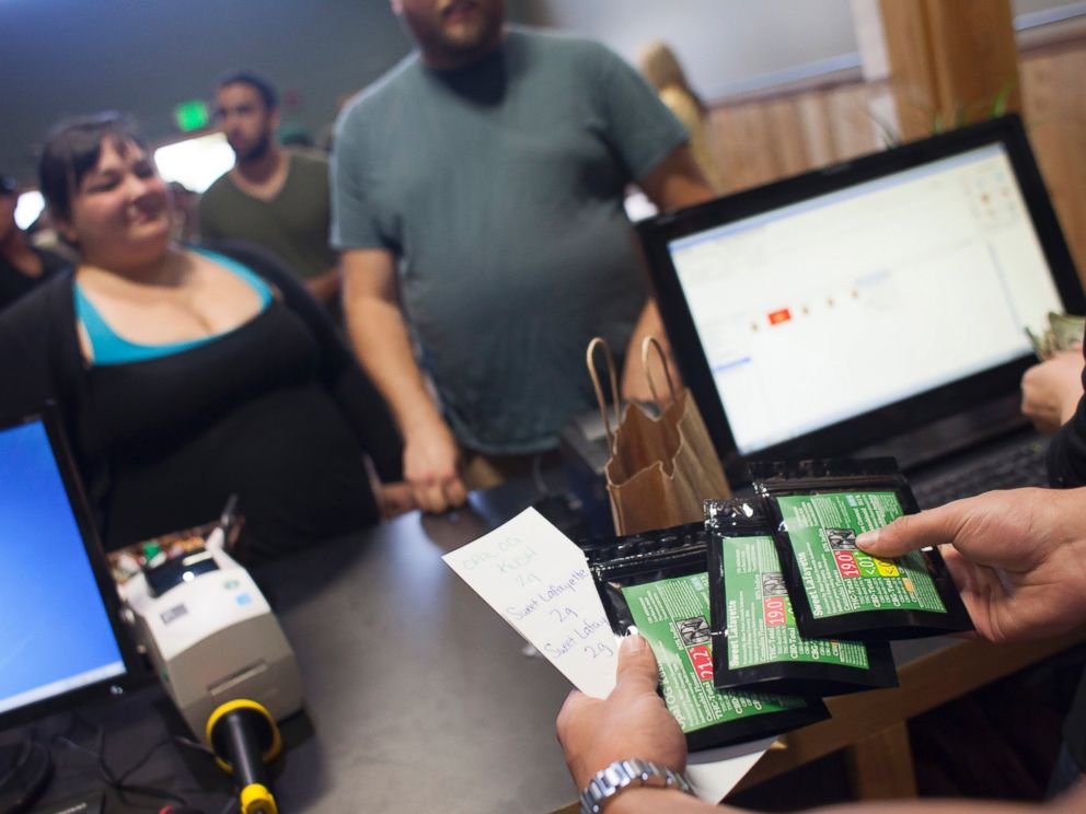 PHOTO: Customers purchase marijuana at Top Shelf Cannabis, a retail marijuana store, on July 8, 2014 in Bellingham, Washington.