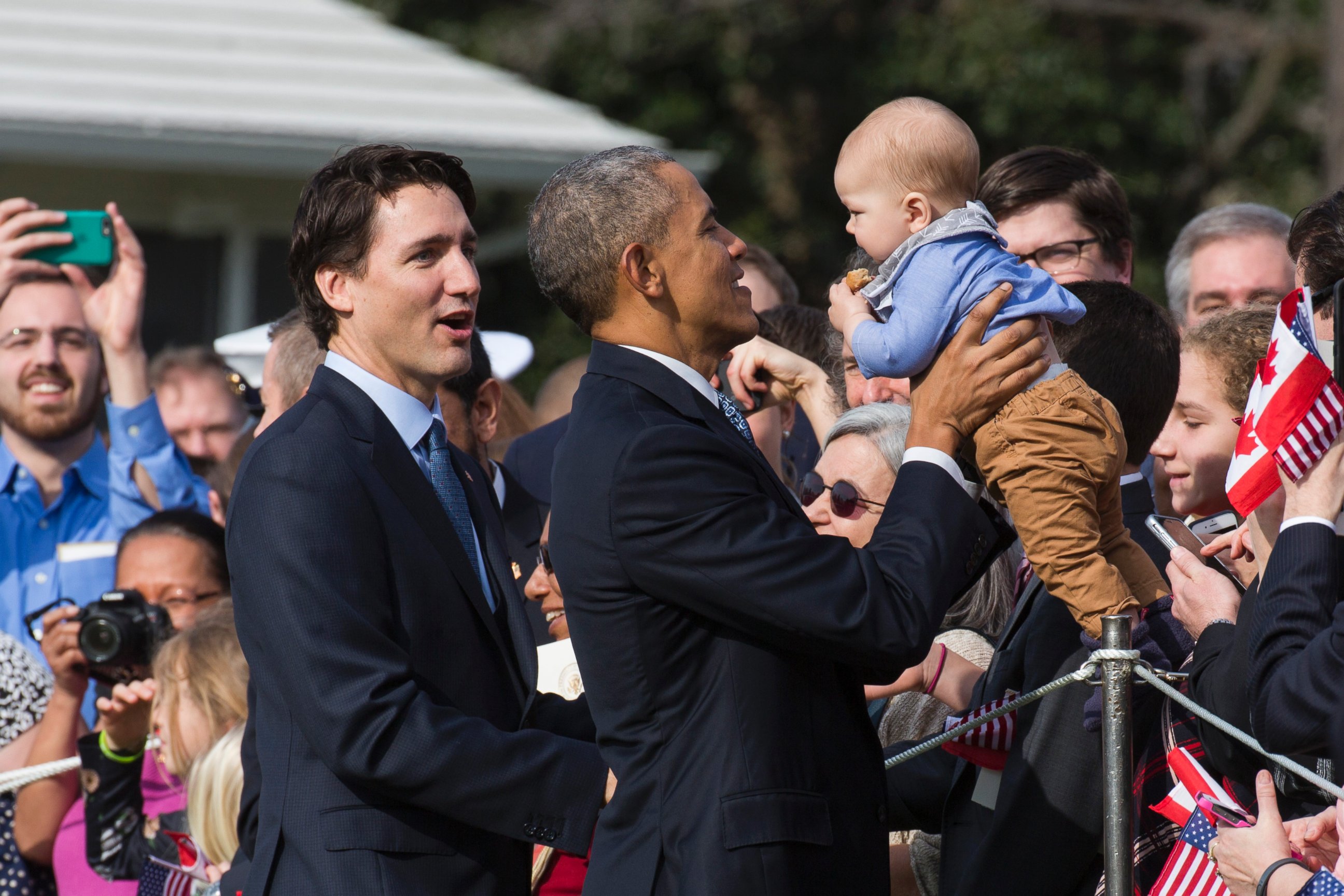 PHOTO: President Barack Obama holds a baby as Canadian Prime Minister Justin Trudeau looks on during an arrival ceremony on the South Lawn of the White House, March 10, 2016 in Washington, D.C.
