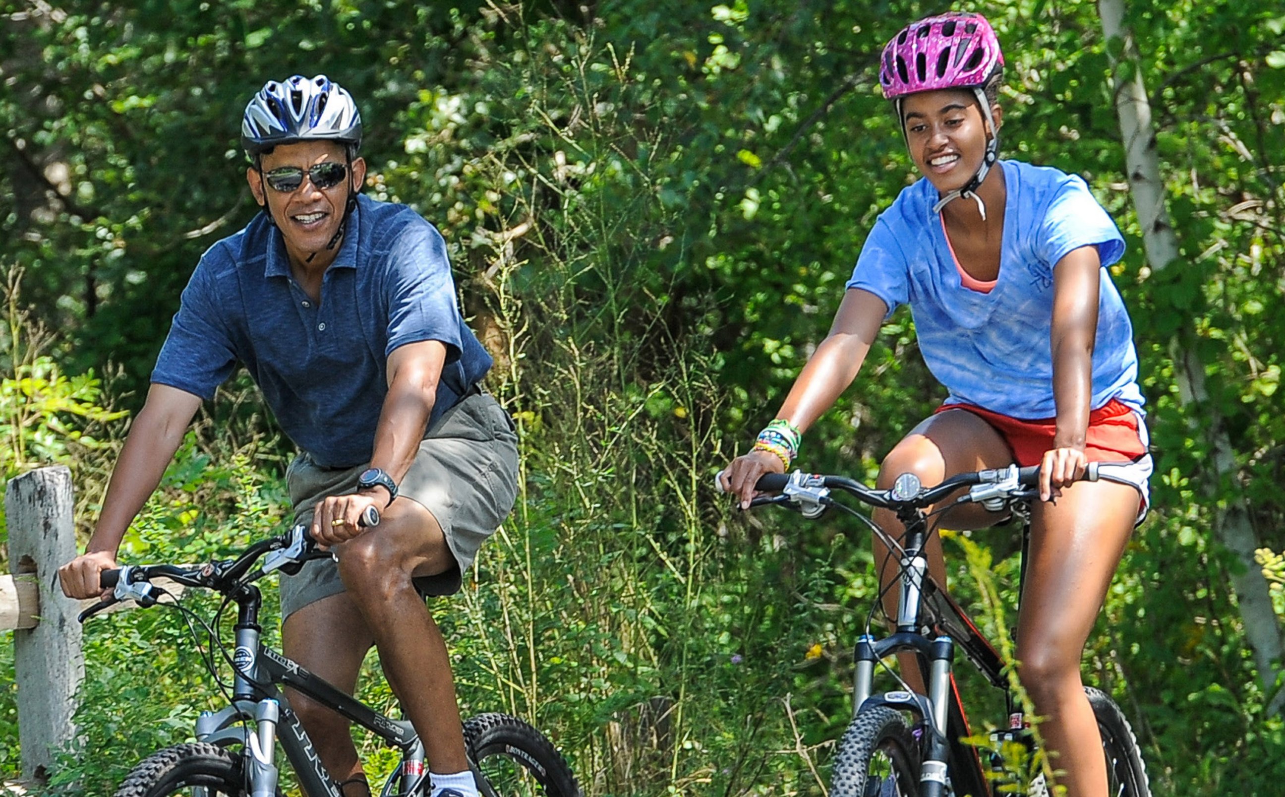 PHOTO: President Barack Obama and his daughter Malia ride bikes during a vacation on Martha's Vineyard on August 16, 2013 in West Tisbury, Mass.