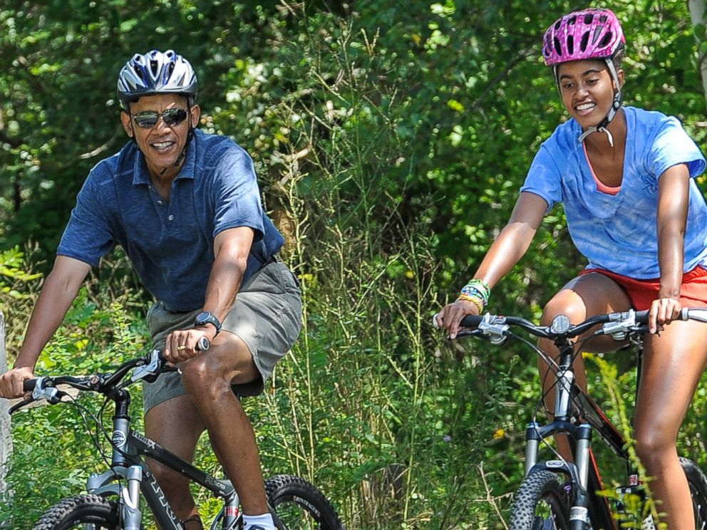 PHOTO: President Barack Obama and his daughter Malia ride bikes during a vacation on Marthas Vineyard on August 16, 2013 in West Tisbury, Mass.