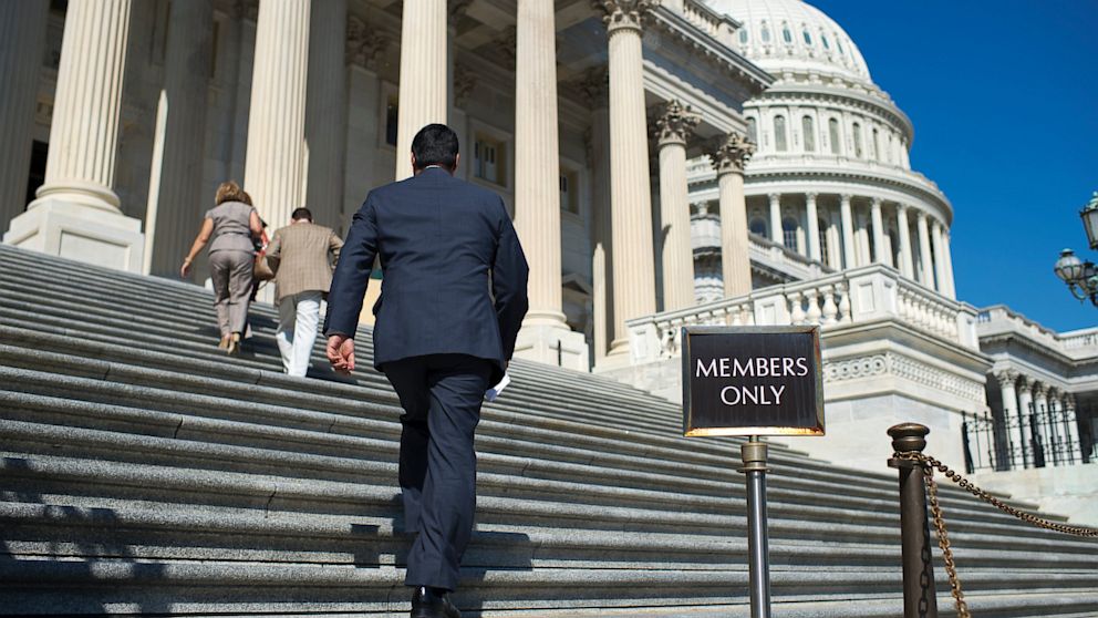 Members of the House of Representatives make their way up the Capitol steps for a vote on a GOP-drafted budget resolution, Sept. 20, 2013, in Washington.