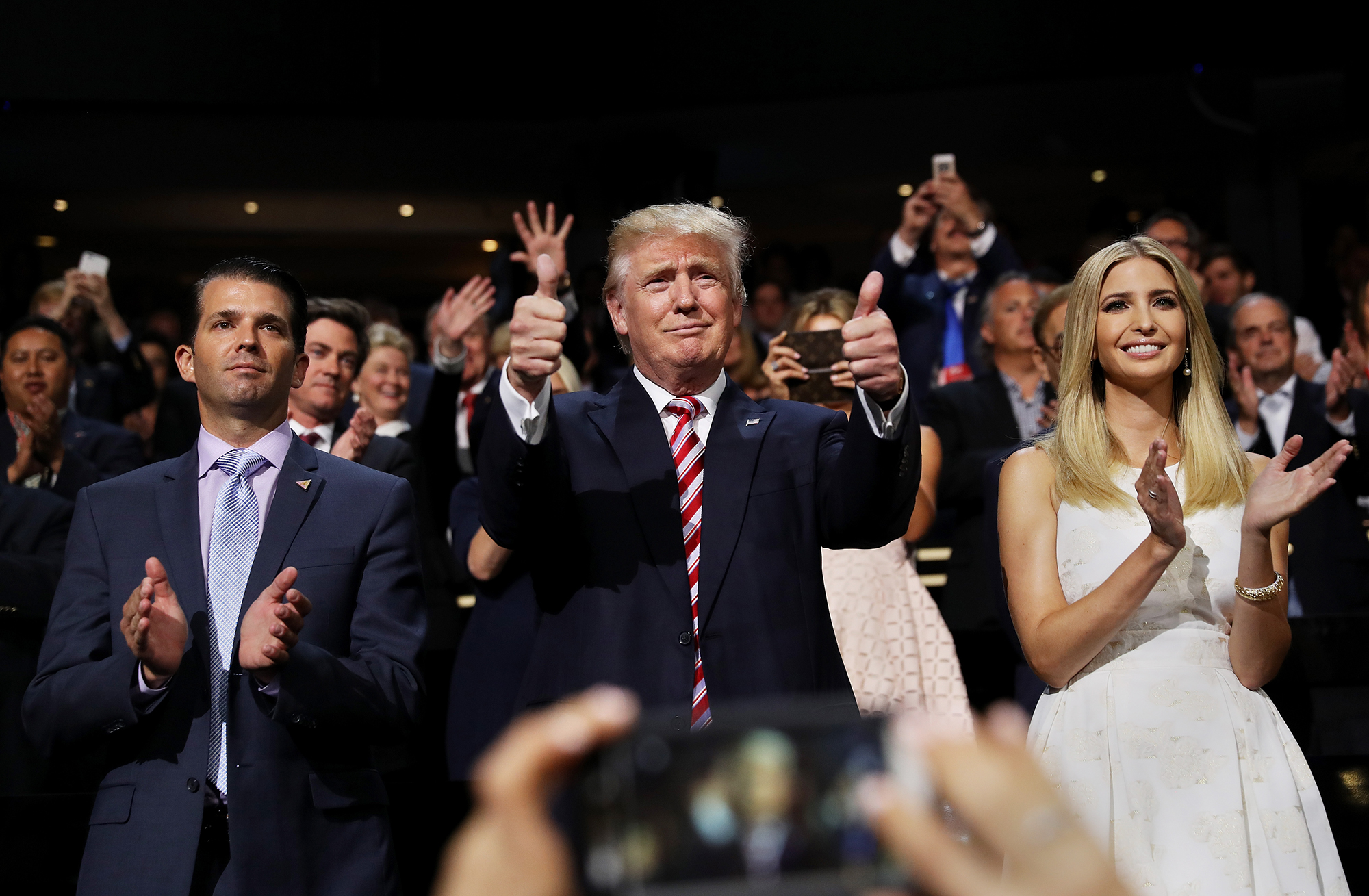 PHOTO: Donald Trump gives two thumbs up as his children, Donald Trump Jr. and Ivanka Trump stand and cheer for their brother, Eric Trump, as he delivers a speech at the Republican National Convention on July 20, 2016 in Cleveland, Ohio. 