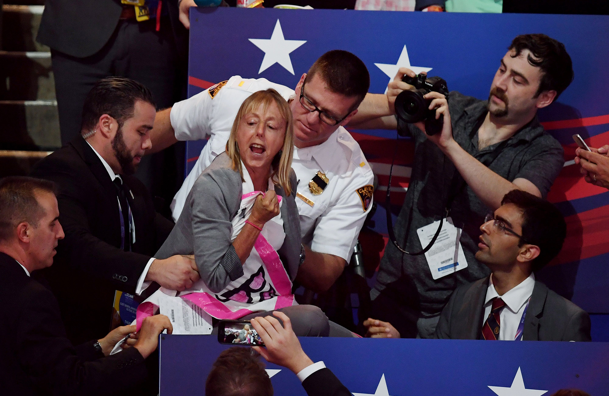 PHOTO: A CODEPINK protester is removed while Republican presidential candidate Donald Trump speaks on the last night of the Republican National Convention on July 21, 2016, in Cleveland.
